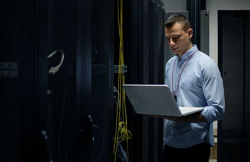 male student on his laptop taking courses for his graduate online certificate in cyber security at the University of the Sunshine Coast